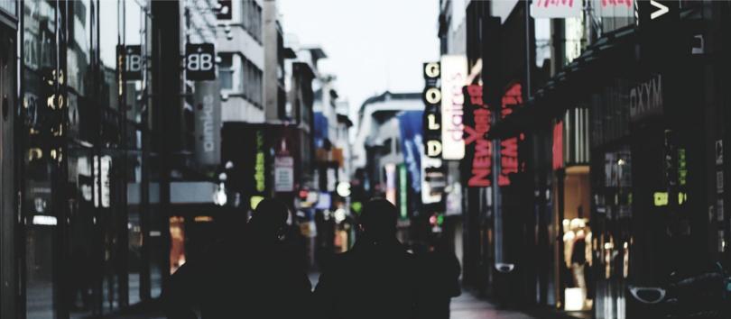 Street with many stores and people walking around